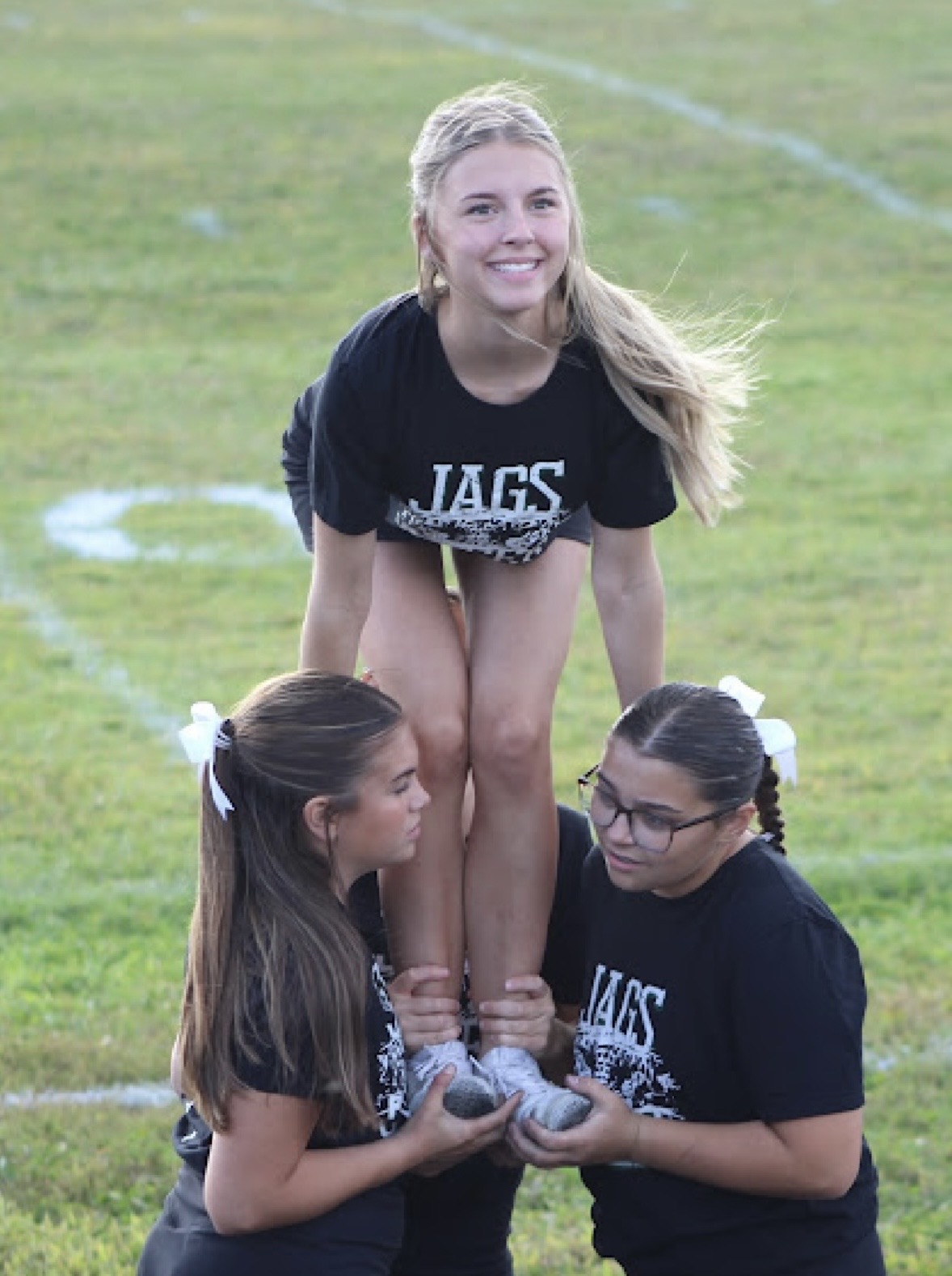 Alyssa Atkinson on top of cheerleading pyramid.